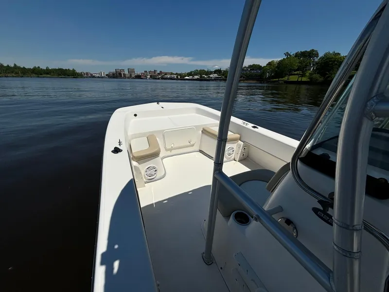 Slide: The Image of 2020 Sundance B22CR boat on calm water with cityscape in background. - 15