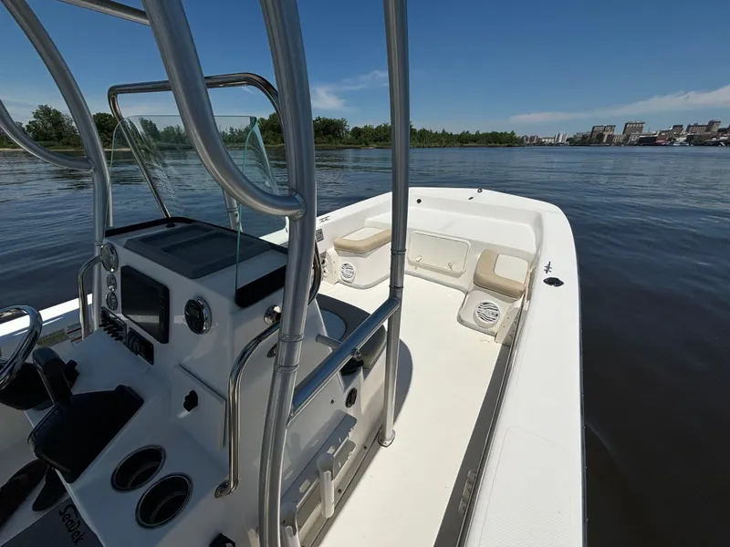Slide: The Image of 2020 Sundance B22CR boat on calm water, featuring sleek design and modern controls. - 16