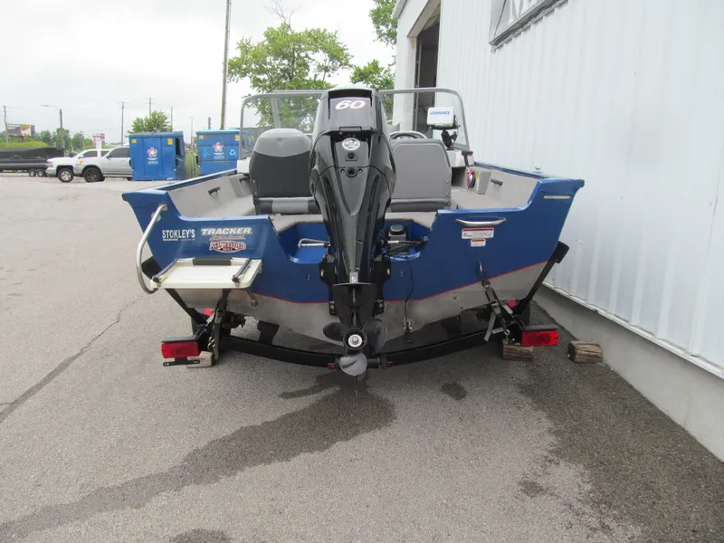 Slide: The Image of 2011 Tracker Pro Guide V-16 WT boat with outboard motor on trailer. - 4
