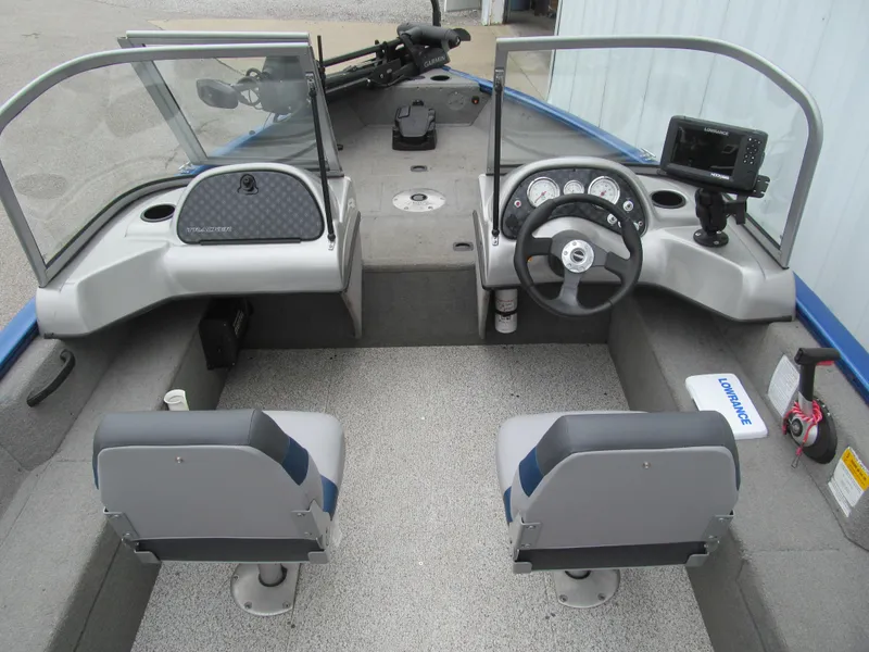 Slide: The Image of 2011 Tracker Pro Guide V-16 WT boat interior with steering wheel and navigation equipment. - 5