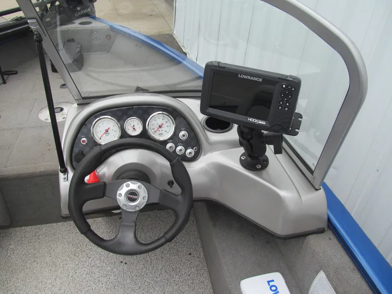 Slide: The Image of 2011 Tracker Pro Guide V-16 WT boat dashboard with steering wheel and Lowrance fishfinder. - 6