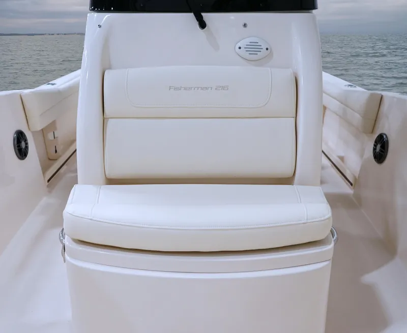 Slide: The Image of 2026 Grady-White Fisherman 216 boat interior with cushioned seating and ocean backdrop. - 13