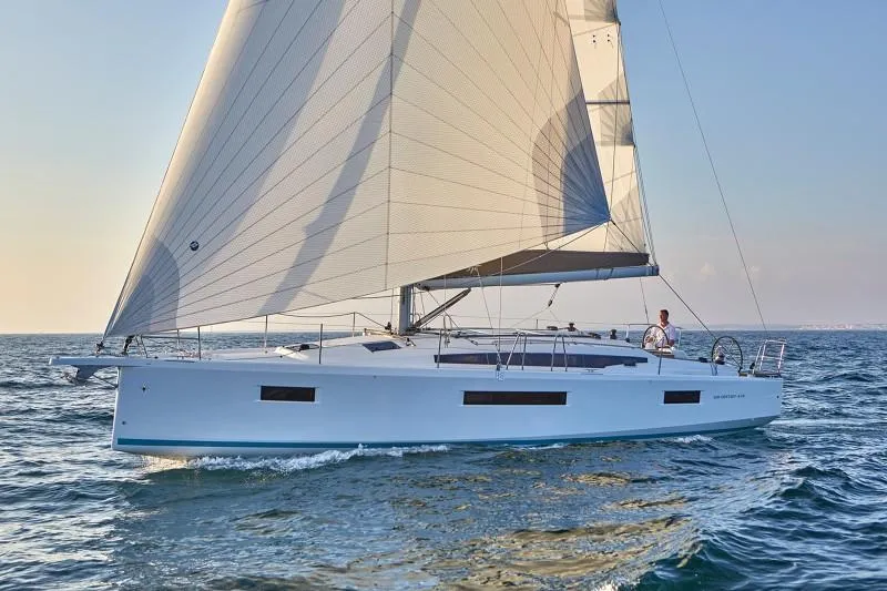 Slide: The Image of 2026 Jeanneau Sun Odyssey 410 sailing on open water under clear skies. - 19
