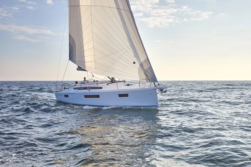 Slide: The Image of 2026 Jeanneau Sun Odyssey 410 sailing on open sea under clear skies. - 20