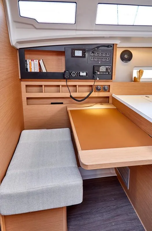 Slide: The Image of Interior of 2026 Jeanneau Sun Odyssey 410, featuring navigation station and seating area. - 5