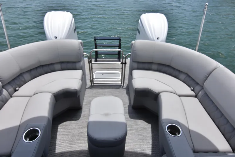 Slide: The Image of 2024 Bennington 27 QFB pontoon boat with luxurious seating on a calm lake. - 39