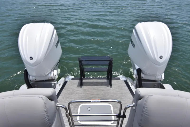 Slide: The Image of 2024 Bennington 27 QFB boat with dual Yamaha outboard motors on water. - 40