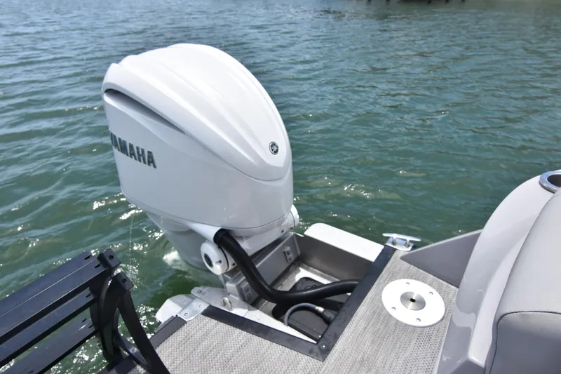 Slide: The Image of 2024 Bennington 27 QFB boat with Yamaha outboard motor on water. - 41
