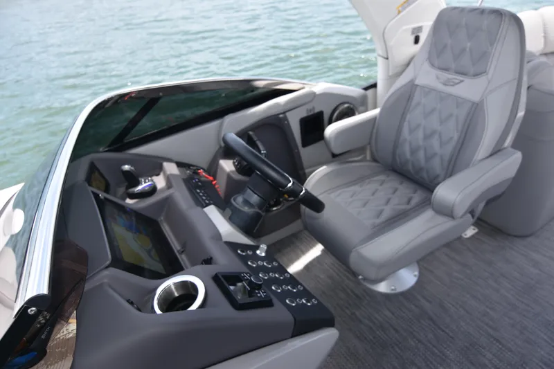 Slide: The Image of 2024 Bennington 27 QFB boat cockpit with luxurious seating and modern controls. - 45
