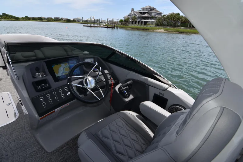 Slide: The Image of 2024 Bennington 27 QFB boat interior with modern dashboard and steering wheel. - 47