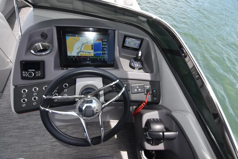 Slide: The Image of 2024 Bennington 27 QFB boat dashboard with navigation screen and controls. - 48