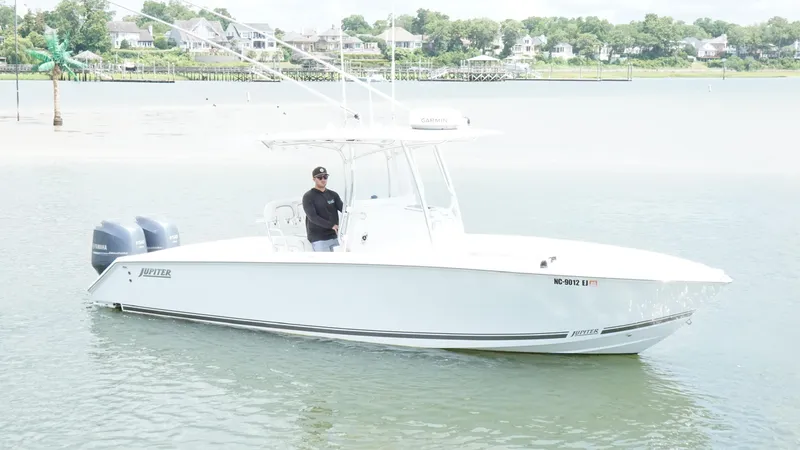 The Image of A 2012 Jupiter 26 boat on calm water with a person onboard. - 1