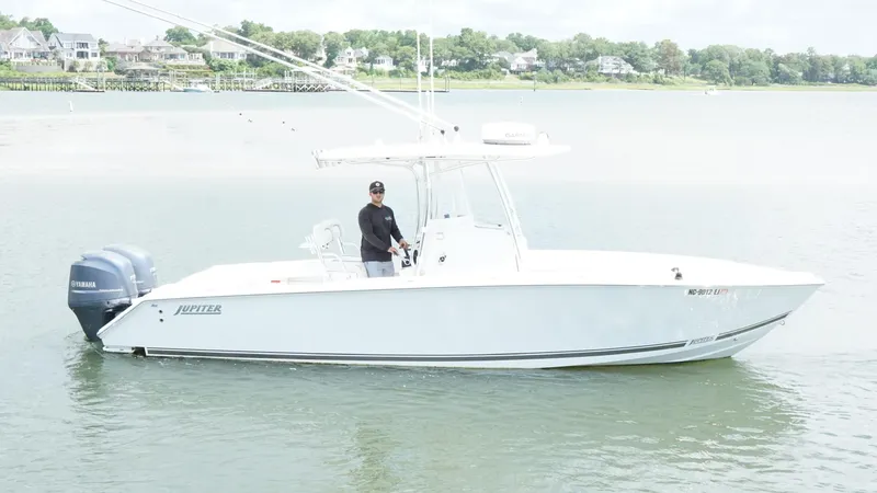 Slide: The Image of 2012 Jupiter 26 boat on water with Yamaha engines, person at helm. - 18