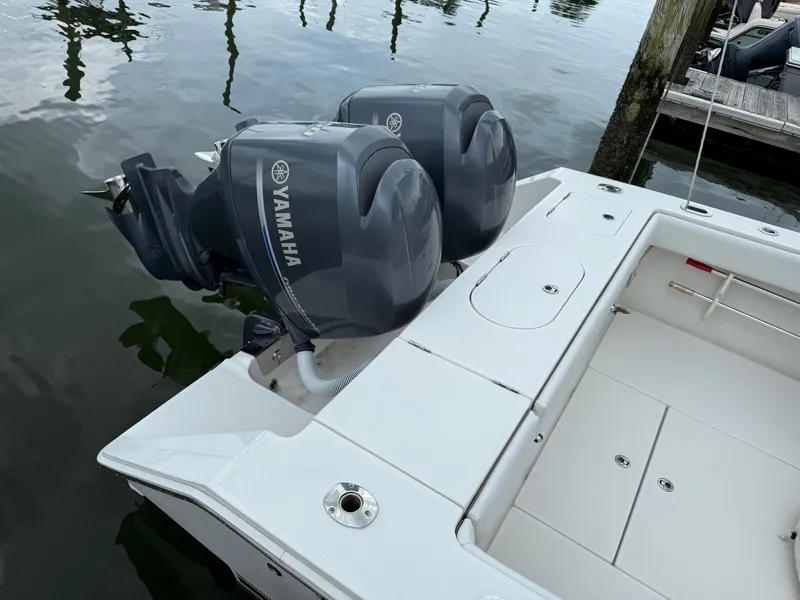 Slide: The Image of Twin Yamaha outboard motors on a 2012 Jupiter 26 boat at a dock. - 20