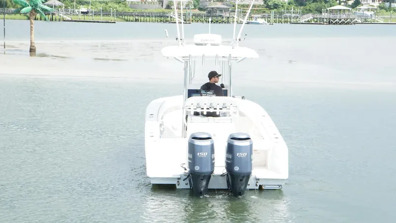 Slide: The Image of A 2012 Jupiter 26 boat with dual Yamaha engines on a calm waterway. - 4