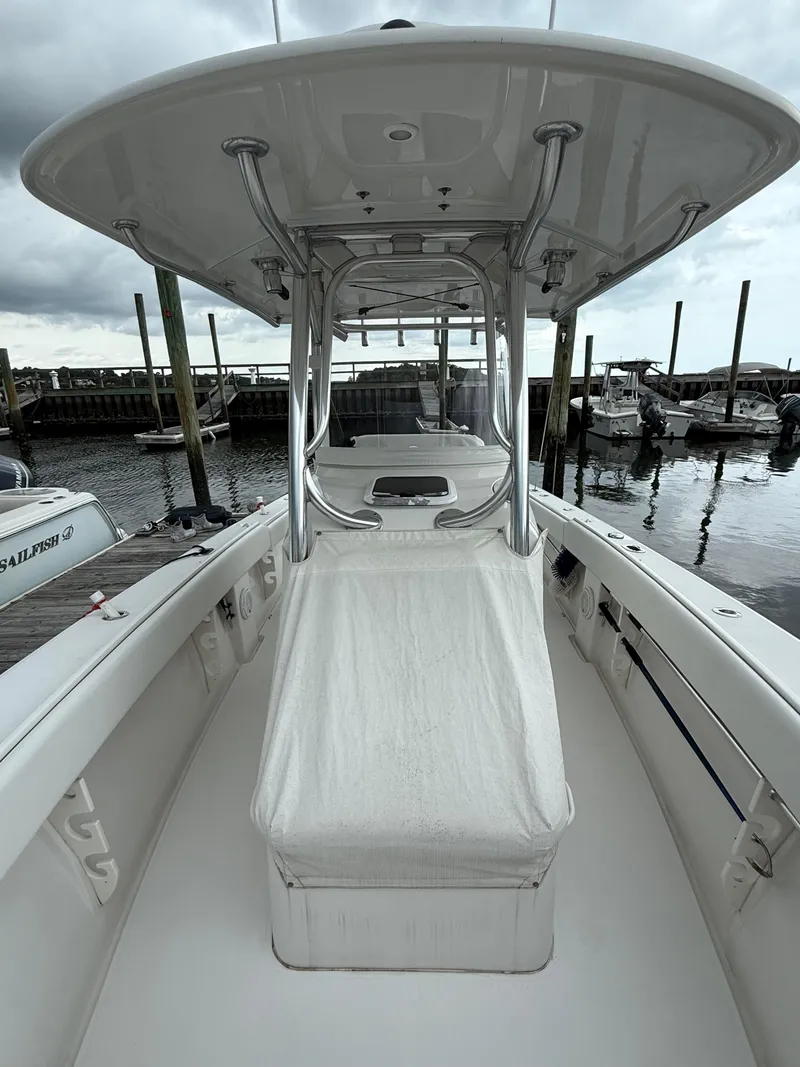 Slide: The Image of 2012 Jupiter 26 boat docked at marina, featuring sleek design and spacious deck. - 6