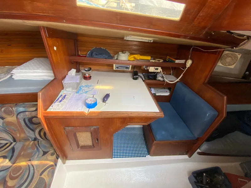 Slide: The Image of 1979 Santana 35 yacht interior with navigation station and blue seating. - 15