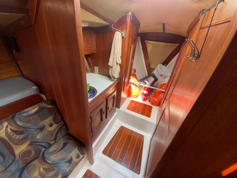 Slide: The Image of 1979 Santana 35 yacht interior with wooden cabinetry and seating area. - 17