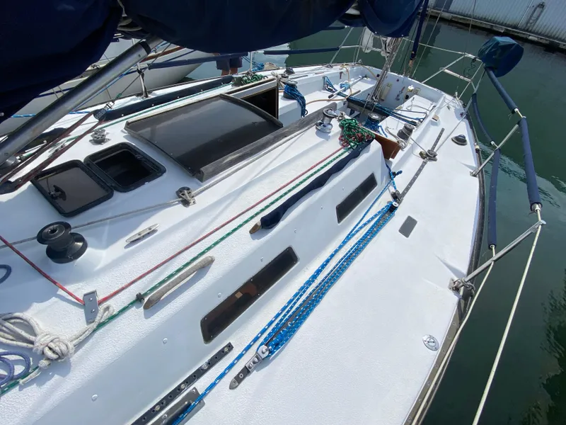 Slide: The Image of 1979 Santana 35 sailboat deck with rigging and hatches in a marina. - 2