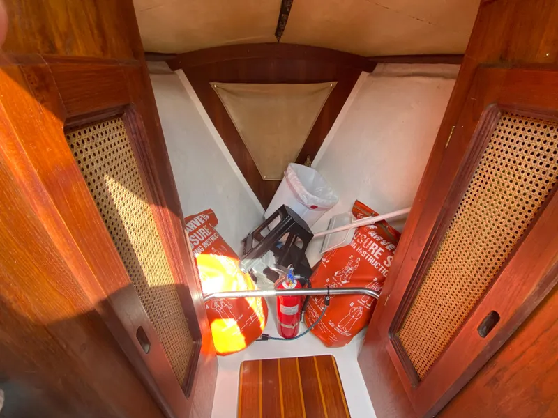 Slide: The Image of Interior of a 1979 Santana 35 sailboat with safety equipment and wooden cabinetry. - 21
