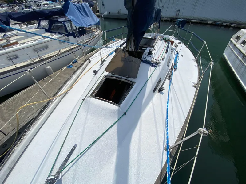 Slide: The Image of 1979 Santana 35 sailboat docked at marina, featuring clean deck and rigging. - 3