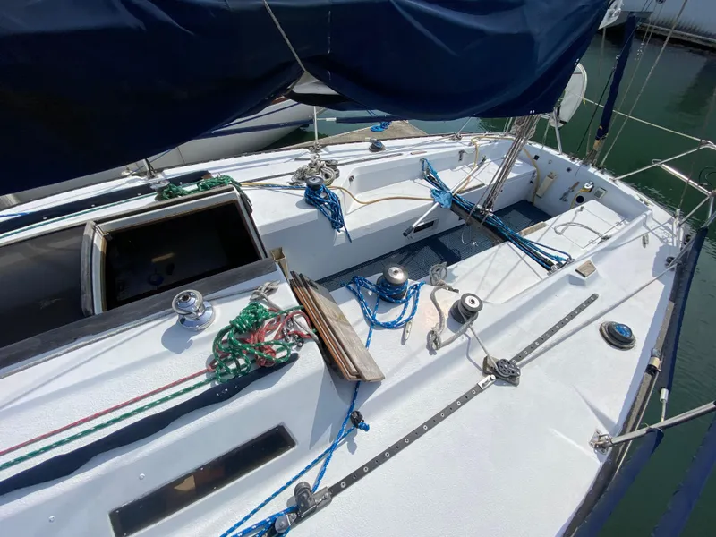 Slide: The Image of 1979 Santana 35 sailboat deck with ropes and winches in a marina. - 6