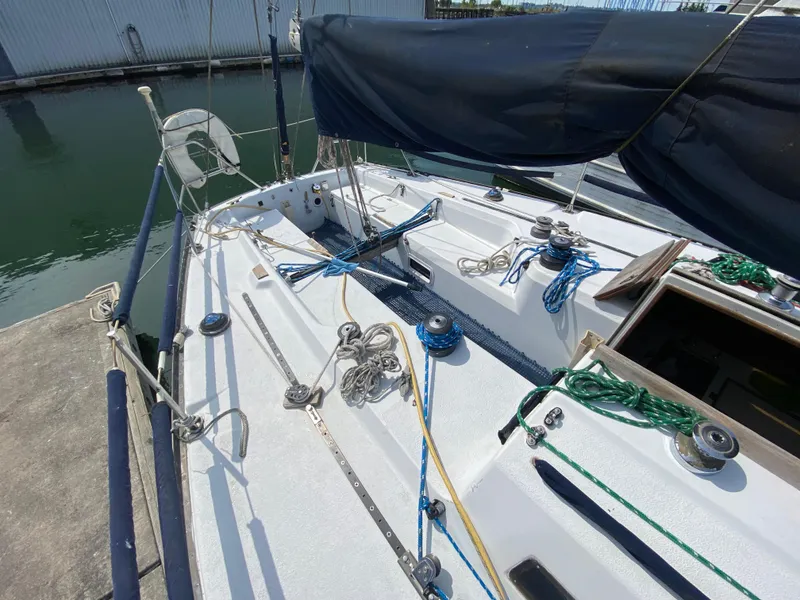 Slide: The Image of 1979 Santana 35 sailboat deck with rigging and winches in a marina. - 7
