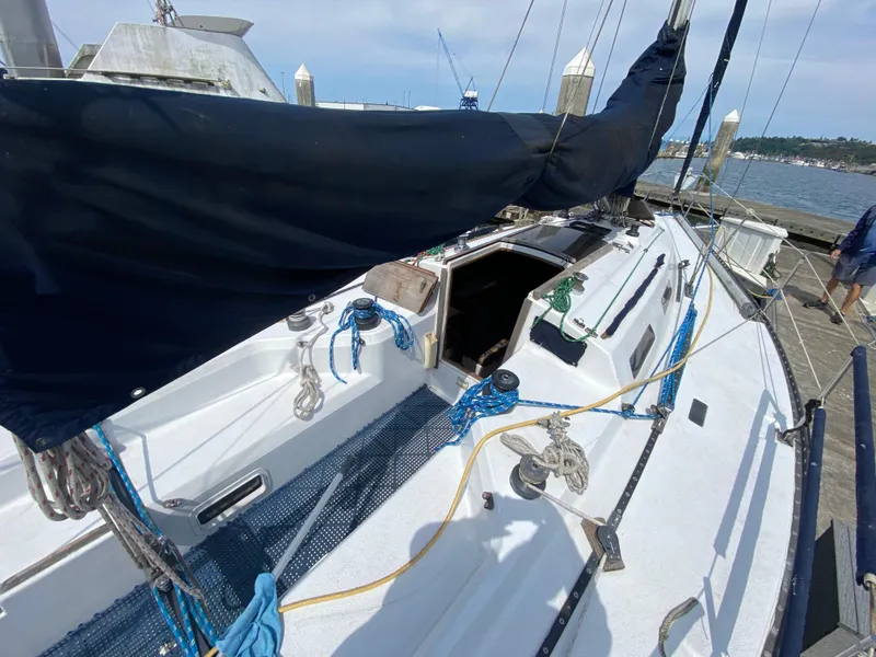 Slide: The Image of 1979 Santana 35 sailboat docked, featuring deck and rigging details. - 8