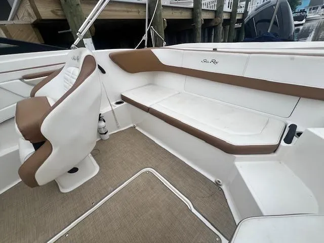Slide: The Image of 2019 Sea Ray SPX 190 OB boat interior with white and brown seating. - 10