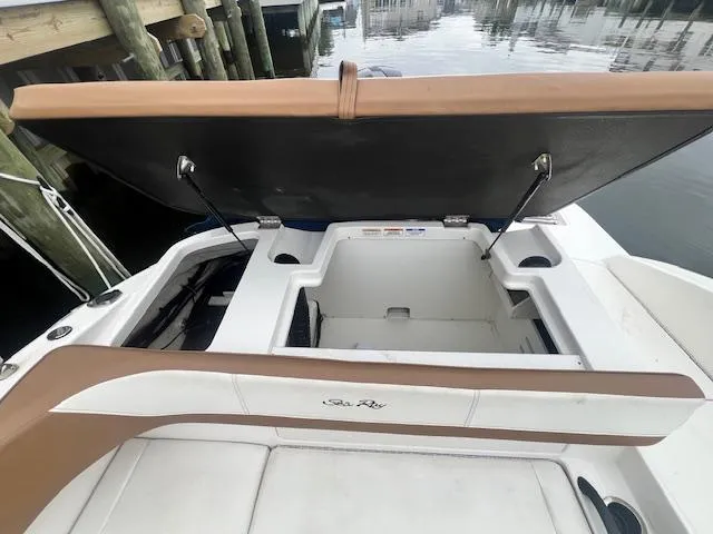 Slide: The Image of 2019 Sea Ray SPX 190 OB boat with open storage compartment by the dock. - 8