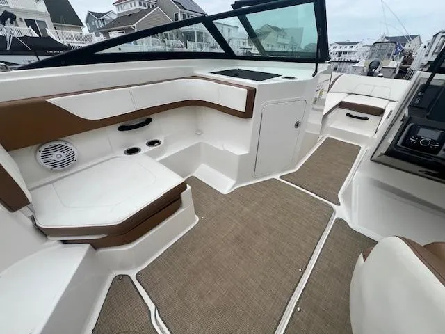 Slide: The Image of 2019 Sea Ray SPX 190 OB boat interior with white and brown seating, modern design. - 9