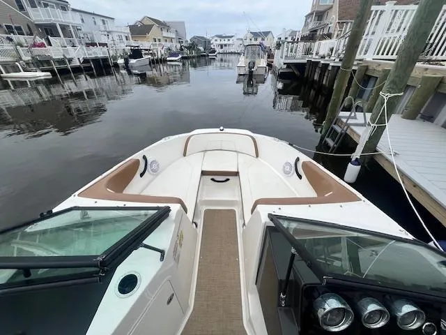 Slide: The Image of 2019 Sea Ray SPX 190 OB boat docked in a residential canal setting. - 12