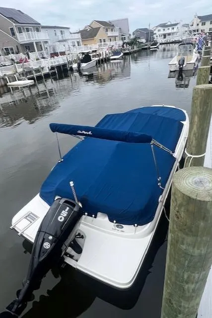 Slide: The Image of 2019 Sea Ray SPX 190 OB boat docked in a residential canal. - 2
