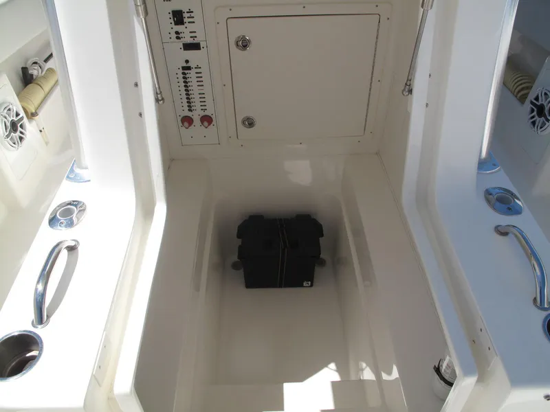 Slide: The Image of 2020 SeaVee 290B boat interior with control panel and storage compartment. - 11