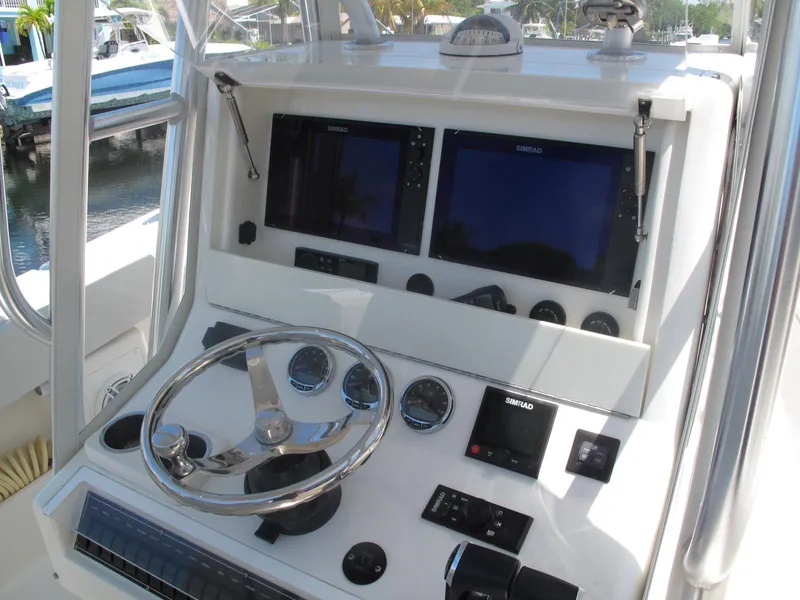 Slide: The Image of 2020 SeaVee 290B boat dashboard with steering wheel and navigation screens. - 13