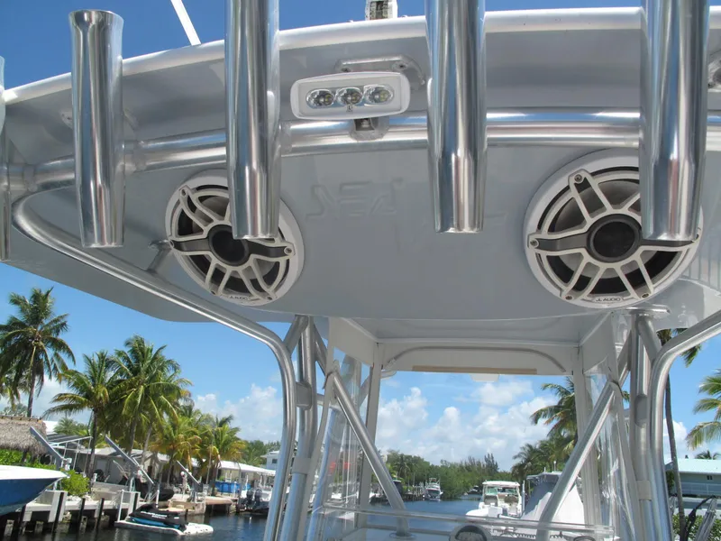 Slide: The Image of 2020 SeaVee 290B boat with speakers and rod holders, docked near palm trees. - 14