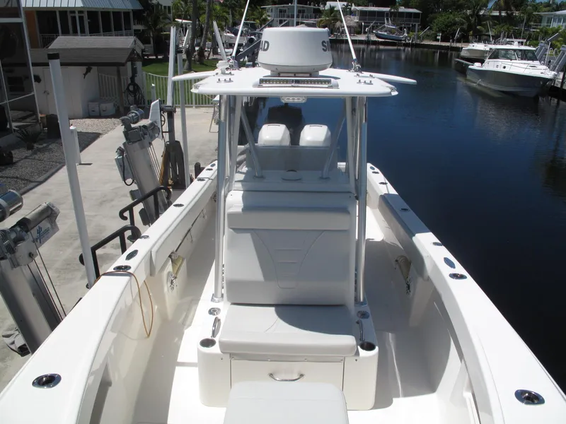 Slide: The Image of 2020 SeaVee 290B boat docked in a marina, featuring a sleek white design. - 20