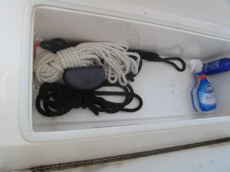 Slide: The Image of Storage compartment on 2020 SeaVee 290B boat with ropes and cleaning supplies. - 23