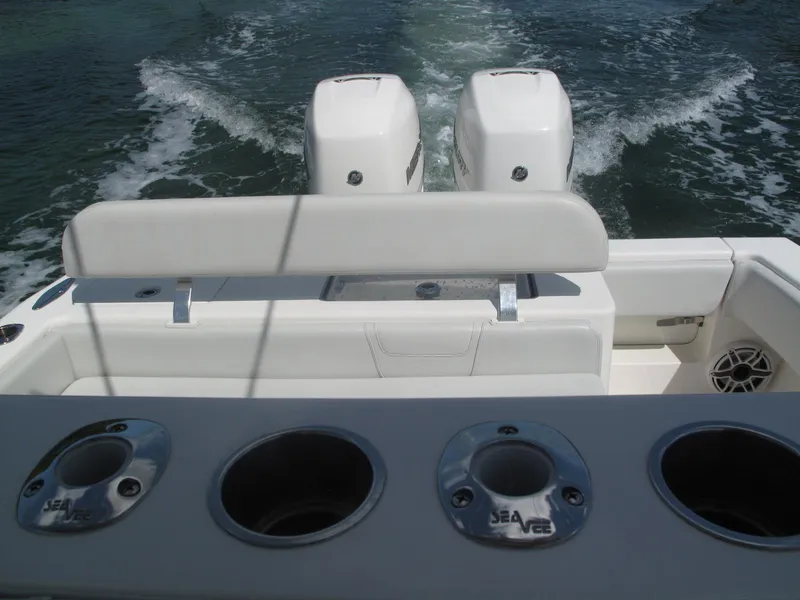 Slide: The Image of 2020 SeaVee 290B boat with dual engines and rod holders on the deck. - 25