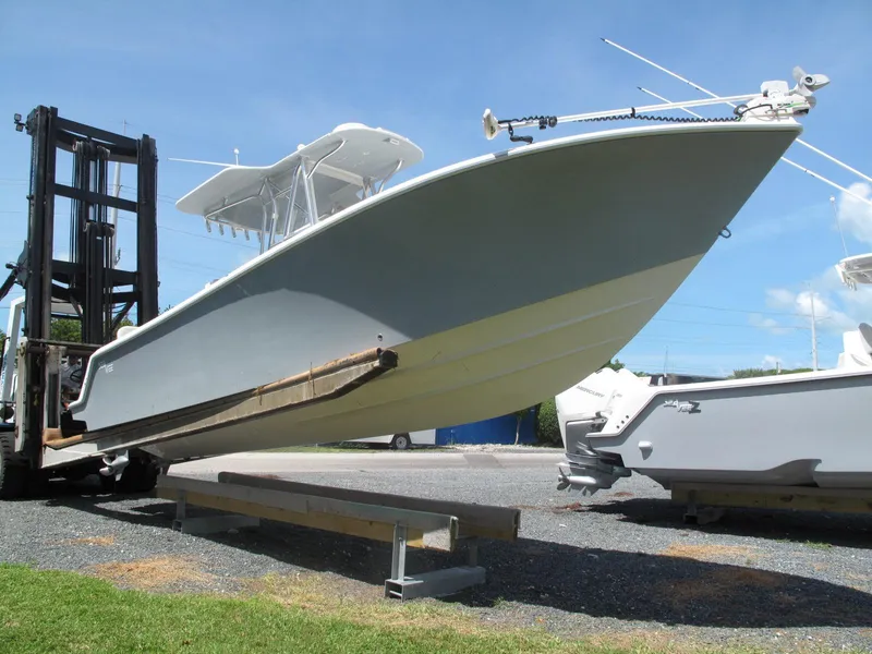 Slide: The Image of 2020 SeaVee 290B boat on forklift, displayed outdoors under clear blue sky. - 27