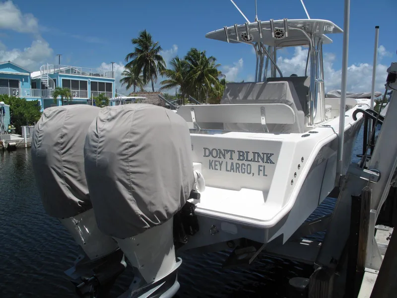 Slide: The Image of 2020 SeaVee 290B boat docked in Key Largo, Florida, with twin covered engines. - 4