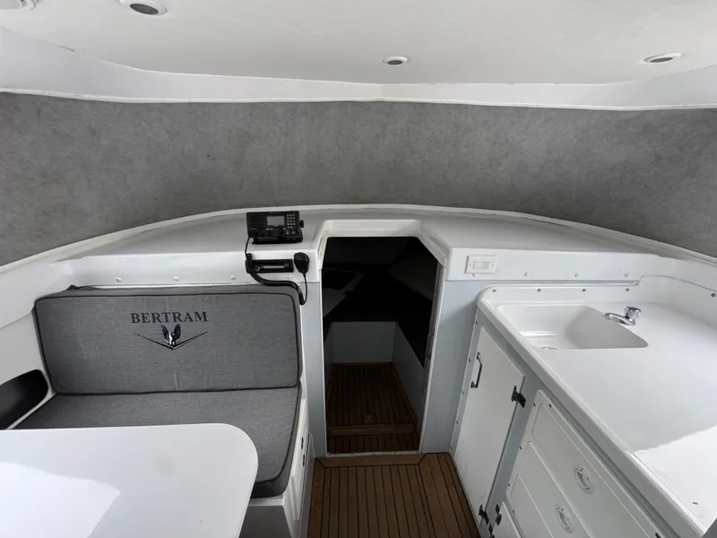 Slide: The Image of 1964 Bertram 31 Flybridge Cruiser interior with seating, sink, and radio equipment. - 10