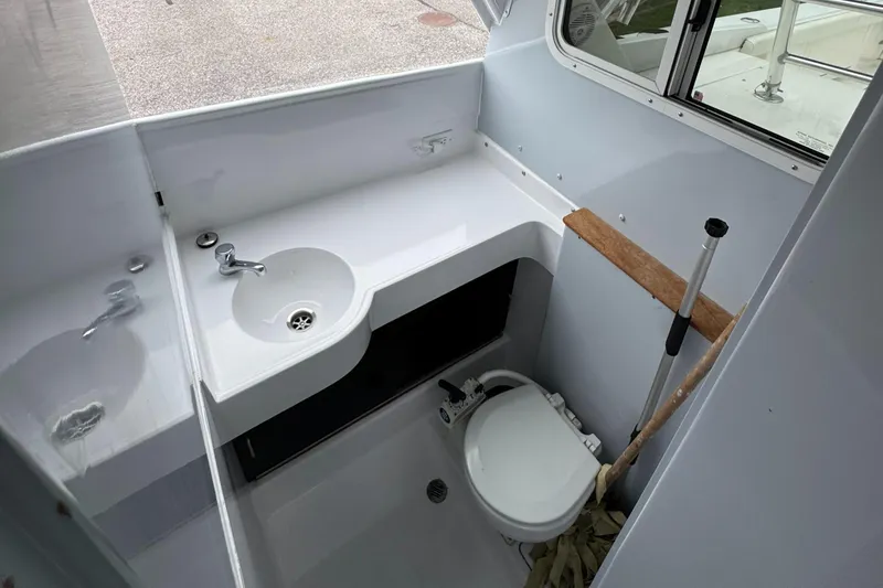 Slide: The Image of 1964 Bertram 31 Flybridge Cruiser bathroom with sink and toilet. - 11