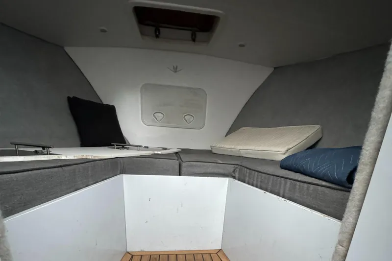 Slide: The Image of Interior cabin of a 1964 Bertram 31 Flybridge Cruiser with cushions and wooden flooring. - 13