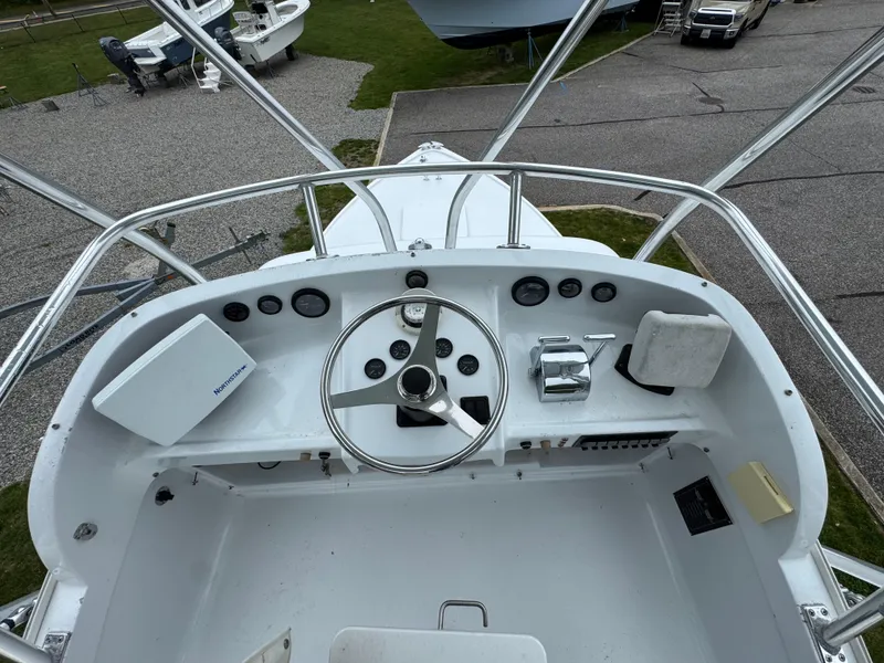 Slide: The Image of 1964 Bertram 31 Flybridge Cruiser helm with steering wheel and controls. - 14