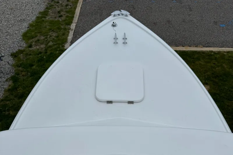 Slide: The Image of 1964 Bertram 31 Flybridge Cruiser bow view, showing deck hatch and cleats. - 18