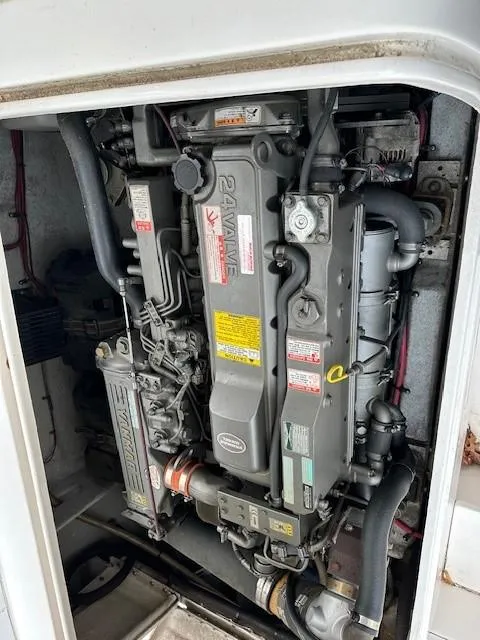 Slide: The Image of Engine compartment of a 1964 Bertram 31 Flybridge Cruiser, showcasing detailed mechanical components. - 19