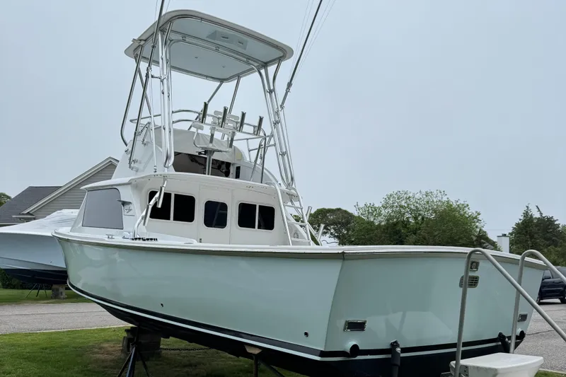 Slide: The Image of 1964 Bertram 31 Flybridge Cruiser on display, showcasing classic design and structure. - 2