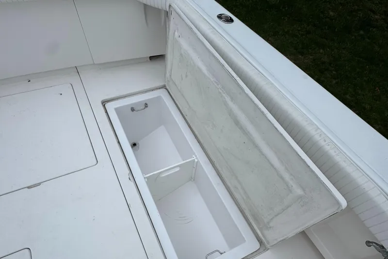 Slide: The Image of Open storage compartment on a 1964 Bertram 31 Flybridge Cruiser boat deck. - 5