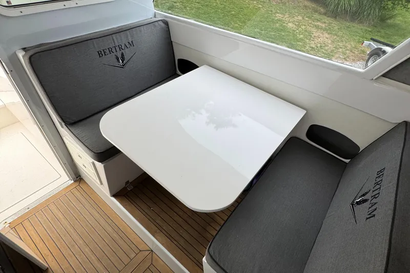 Slide: The Image of Interior of a 1964 Bertram 31 Flybridge Cruiser with a sleek dining area. - 8